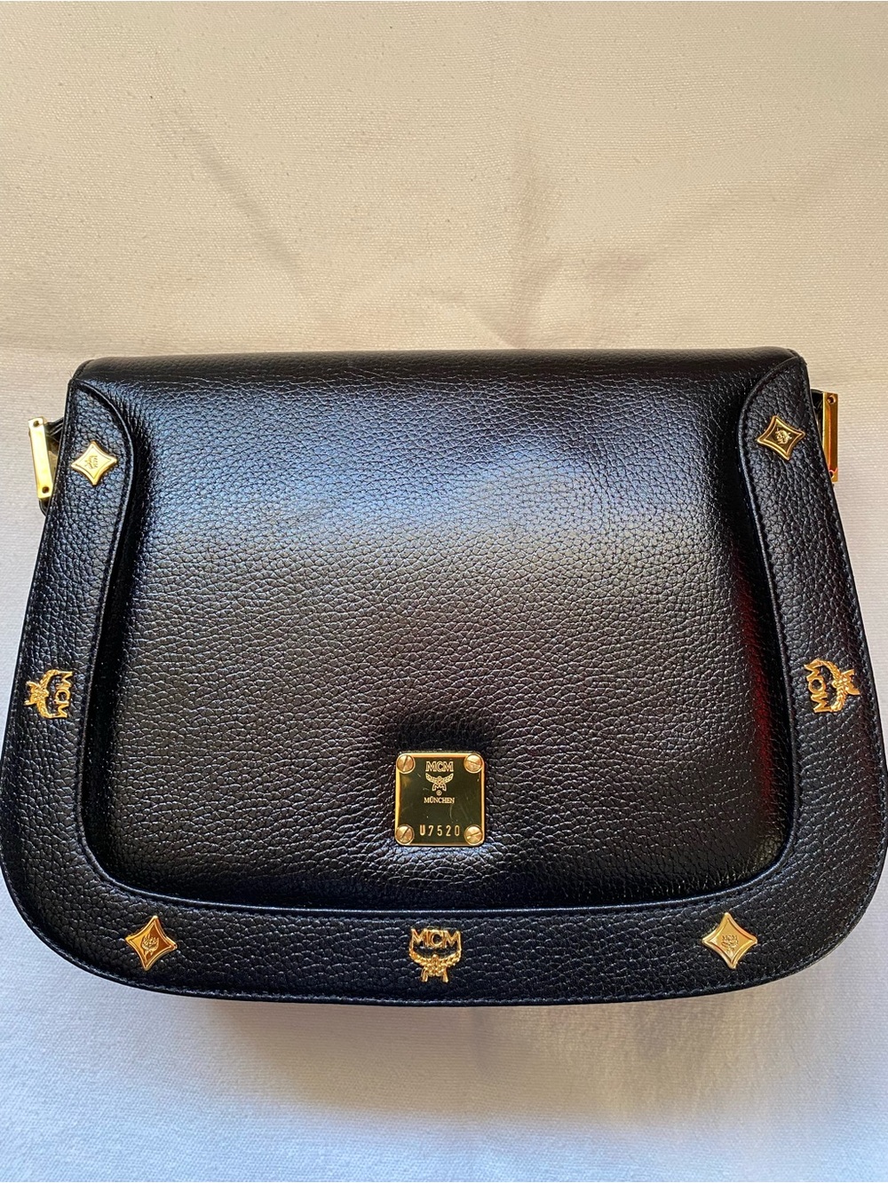 MCM Black Leather Shoulder Bag with Gold Emblem Accents
